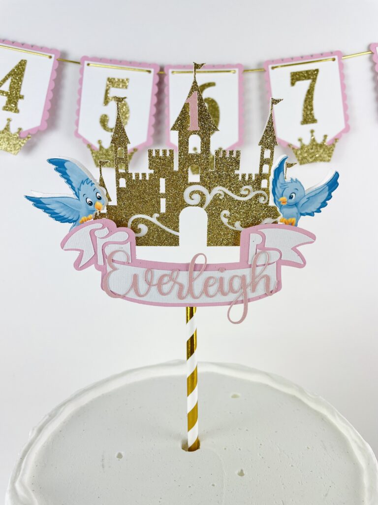 Princess castle cake topper with gold glitter castle, blue birds, and name banner